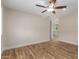 Spacious bedroom with wood flooring, a ceiling fan, and a view into the bathroom at 10318 E Michigan Ave, Sun Lakes, AZ 85248