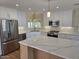 Spacious kitchen featuring an island, stainless steel appliances, and white cabinets at 10318 E Michigan Ave, Sun Lakes, AZ 85248