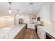 Bright kitchen featuring white cabinets, stainless steel appliances, and a large island with quartz countertops at 10318 E Michigan Ave, Sun Lakes, AZ 85248