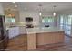 Bright kitchen with stainless appliances, center island, and ample cabinet space at 10318 E Michigan Ave, Sun Lakes, AZ 85248
