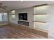 Open living room with recessed lights, fireplace, feature wall, and wood-look floors at 10318 E Michigan Ave, Sun Lakes, AZ 85248