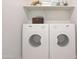 Well-lit laundry area with a Zanussi washer and dryer and shelf for storage convenience at 1219 N 13Th St, Coolidge, AZ 85128
