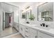 Sleek bathroom showcasing dual vanity sinks and modern fixtures, adjacent to glass enclosed shower at 12222 N Paradise Village S Pkwy # 237, Phoenix, AZ 85032
