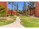 Beautiful landscaped grounds with mature trees and a winding walkway leading to the amenities at 12222 N Paradise Village S Pkwy # 237, Phoenix, AZ 85032