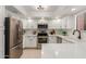 Bright kitchen features modern appliances, white cabinetry, quartz countertops and ample counter space at 12222 N Paradise Village S Pkwy # 237, Phoenix, AZ 85032