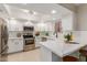 Bright kitchen features modern appliances, white cabinetry, and quartz countertops at 12222 N Paradise Village S Pkwy # 237, Phoenix, AZ 85032