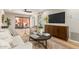 Inviting living room featuring modern decor, access to an outdoor patio, and entertainment center at 12222 N Paradise Village S Pkwy # 237, Phoenix, AZ 85032