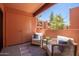 Inviting patio area featuring comfortable wicker seating, a small table, and views of the exterior at 12222 N Paradise Village S Pkwy # 237, Phoenix, AZ 85032