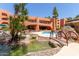 The home features a serene pool area with a decorative bridge, lush landscaping, and a relaxing atmosphere for outdoor enjoyment at 12222 N Paradise Village S Pkwy # 237, Phoenix, AZ 85032