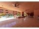 Spacious pool area under covered patio offers tables, chairs, and a view of the pool and waterfall at 12222 N Paradise Village S Pkwy # 237, Phoenix, AZ 85032