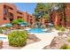Resort-style community pool featuring a faux rock waterfall, lounge chairs and lush landscaping at 12222 N Paradise Village S Pkwy # 237, Phoenix, AZ 85032