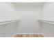 A freshly painted and empty walk-in closet with rod and shelving awaiting personal customization at 12222 N Paradise Village S Pkwy # 237, Phoenix, AZ 85032