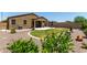 Spacious backyard showcasing a covered patio, healthy lawn, and attractive landscaping for outdoor relaxation at 128 S 200Th Ave, Buckeye, AZ 85326