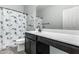 Bright bathroom showcases a charming vanity, tile floor, and stylish nautical themed shower curtain at 128 S 200Th Ave, Buckeye, AZ 85326