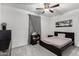 Cozy bedroom with ceiling fan, bedside table, and framed wall art at 128 S 200Th Ave, Buckeye, AZ 85326