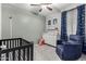Charming Bedroom features a comfortable rocker, a changing table, and space themed wall décor at 128 S 200Th Ave, Buckeye, AZ 85326