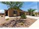 Inviting single-story home with desert landscaping, a two-car garage, and mature trees at 128 S 200Th Ave, Buckeye, AZ 85326
