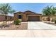 Charming single-story home featuring a desert-landscaped front yard and a two-car garage at 128 S 200Th Ave, Buckeye, AZ 85326