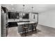 The gorgeous kitchen boasts marble countertops, black cabinetry and a center island with barstool seating at 128 S 200Th Ave, Buckeye, AZ 85326