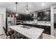 Stunning kitchen features an island, marble countertops, stainless steel appliances, and dark wood cabinetry at 128 S 200Th Ave, Buckeye, AZ 85326