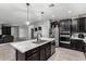 This open kitchen features a center island, stainless steel appliances and a seamless flow to the living area at 128 S 200Th Ave, Buckeye, AZ 85326