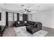 Spacious living room boasts tile floors, ample lighting, and comfortable sectional sofa at 128 S 200Th Ave, Buckeye, AZ 85326