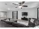 Comfortable living room features a ceiling fan, TV, plush sectional sofa and modern decor at 128 S 200Th Ave, Buckeye, AZ 85326
