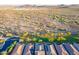 Expansive aerial view of homes backing to natural desert landscape, showcasing community living and beautiful mountain views at 13719 W Amberwing St, Peoria, AZ 85383