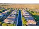 Wide aerial perspective shows neatly planned community with solar panels, green landscaping and desert backdrop at 13719 W Amberwing St, Peoria, AZ 85383