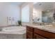 Relaxing bathroom with a soaking tub, granite counters, and a walk-in shower at 13719 W Amberwing St, Peoria, AZ 85383