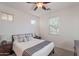 Inviting bedroom with natural light, a ceiling fan, and soft carpeting at 13719 W Amberwing St, Peoria, AZ 85383