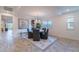 Elegant dining room with stylish chandelier, rug, and adjacent open-concept living space at 13719 W Amberwing St, Peoria, AZ 85383