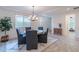 Bright dining room featuring a modern chandelier, rug and a view of the bedroom at 13719 W Amberwing St, Peoria, AZ 85383