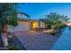 Charming home featuring a two-car garage, stone accents, manicured landscaping and inviting outdoor lighting at 13719 W Amberwing St, Peoria, AZ 85383