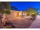 Charming home with a brick driveway, well-maintained landscaping, and a two-car garage at 13719 W Amberwing St, Peoria, AZ 85383