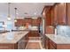 Gorgeous kitchen with dark cabinets, granite countertops, and stainless steel appliances at 13719 W Amberwing St, Peoria, AZ 85383