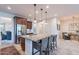 Modern kitchen featuring a large island, granite countertops, stainless steel appliances, and pendant lighting at 13719 W Amberwing St, Peoria, AZ 85383