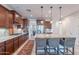 Full kitchen view showcasing a large island with seating, ample cabinet space, and stainless steel appliances at 13719 W Amberwing St, Peoria, AZ 85383
