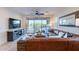 Cozy living room with plush leather seating and sliding doors to the pool area at 13719 W Amberwing St, Peoria, AZ 85383