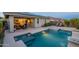 Backyard pool and patio area offers a tranquil outdoor retreat, complete with spa and landscaped surroundings at 13719 W Amberwing St, Peoria, AZ 85383