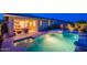 Inviting backyard pool and spa with beautiful landscaping and a covered patio seating area, perfect for outdoor entertaining at 13719 W Amberwing St, Peoria, AZ 85383