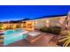 Stunning backyard oasis with a refreshing pool and spa, complemented by a covered patio and well-maintained landscaping at 13719 W Amberwing St, Peoria, AZ 85383