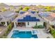 Gorgeous backyard oasis features a sparkling pool, spa, covered patio and solar panels for energy efficiency at 13719 W Amberwing St, Peoria, AZ 85383