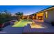 Inviting backyard features a shimmering pool, relaxing spa, and outdoor lighting, perfect for evening relaxation at 13719 W Amberwing St, Peoria, AZ 85383