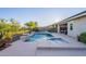 Inviting backyard pool and spa area with desert landscaping for privacy and relaxation at 13719 W Amberwing St, Peoria, AZ 85383