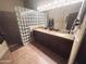 Bright bathroom featuring a double vanity, granite countertops, and glass block shower at 14000 N 94Th St # 1077, Scottsdale, AZ 85260