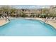 Refreshing community pool surrounded by lounge chairs, ideal for relaxation and social gatherings at 14000 N 94Th St # 1077, Scottsdale, AZ 85260