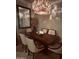 Cozy dining room with a modern chandelier and seating for six people at 14000 N 94Th St # 1077, Scottsdale, AZ 85260