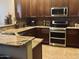 Chef's kitchen features stainless steel appliances, granite countertops, and custom cabinetry at 14000 N 94Th St # 1077, Scottsdale, AZ 85260
