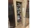Well-stocked pantry with shelves, food, and beverages next to the refrigerator at 14000 N 94Th St # 1077, Scottsdale, AZ 85260